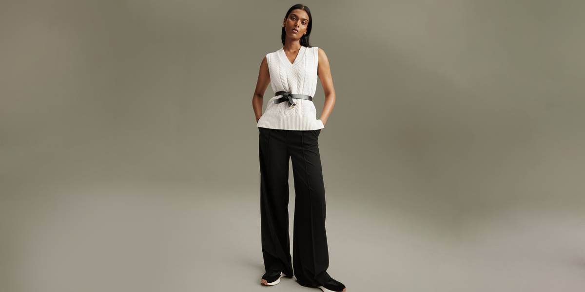 Woman wearing white top and black pants 